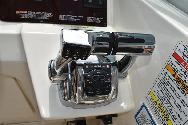 Windy Gale IV Yacht Photos Pics Throttle controls on a 2011 Sea Ray 310 Sundancer boat dashboard with warning labels.