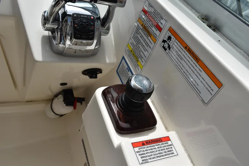 Windy Gale IV Yacht Photos Pics Control panel of 2011 Sea Ray 310 Sundancer with joystick and warning labels.