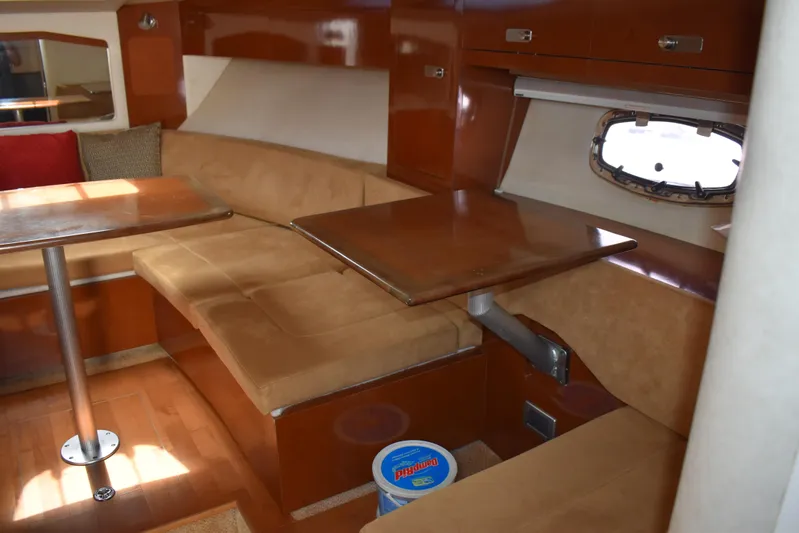 Windy Gale IV Yacht Photos Pics Interior of 2011 Sea Ray 310 Sundancer with cozy seating and wooden table.