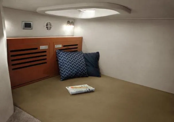 Windy Gale IV Yacht Photos Pics Cozy cabin interior of 2011 Sea Ray 310 Sundancer with pillows and book.