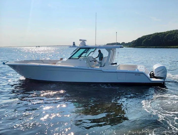  Yacht Photos Pics 2022 Bertram 39 CC boat cruising on a sunny day in open water.