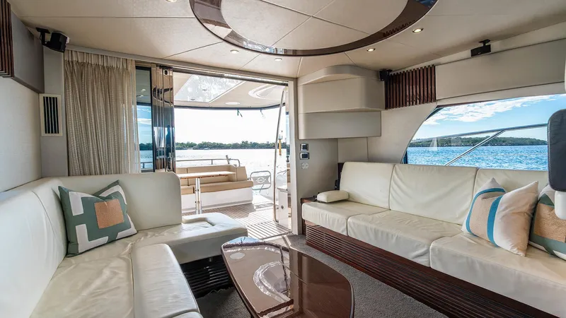 Cloud Catcher Yacht Photos Pics Luxurious interior of 2014 Sunseeker Manhattan 55 yacht with elegant seating and scenic ocean view.