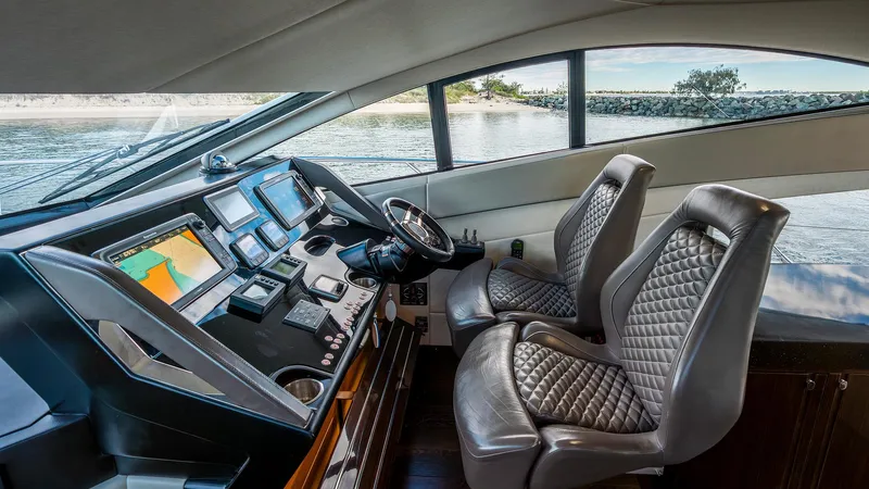 Cloud Catcher Yacht Photos Pics Luxurious 2014 Sunseeker Manhattan 55 yacht cockpit with modern navigation equipment and leather seats.