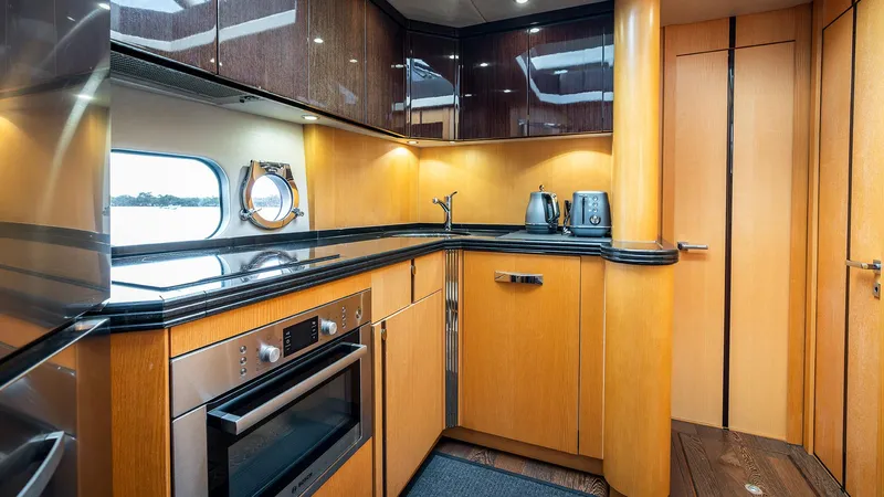 Cloud Catcher Yacht Photos Pics Luxurious kitchen interior of 2014 Sunseeker Manhattan 55 yacht with modern appliances.