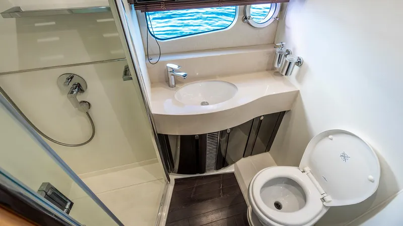 Cloud Catcher Yacht Photos Pics Luxurious bathroom on 2014 Sunseeker Manhattan 55 yacht with shower, sink, and toilet.