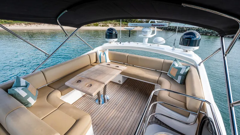 Cloud Catcher Yacht Photos Pics Luxurious Sunseeker Manhattan 55 yacht deck with seating, 2014 model, overlooking serene waters.