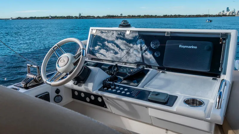 Cloud Catcher Yacht Photos Pics Cockpit of 2014 Sunseeker Manhattan 55 yacht with steering wheel and navigation equipment.