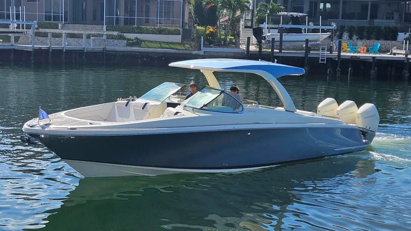 Launch 35 Gt Yacht Photos Pics 2021 Chris-Craft Launch 35 GT boat cruising on calm water near a dock.