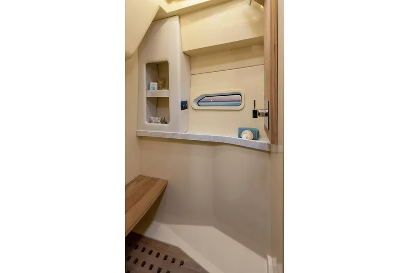  Yacht Photos Pics Manufacturer Provided Image: Interior of 2025 Regal 38 FXO boat, featuring a compact, modern bathroom with shelving.