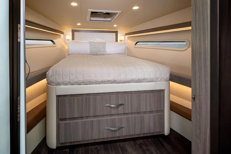  Yacht Photos Pics Manufacturer Provided Image: Luxurious cabin interior of 2025 Regal 38 FXO yacht with cozy bed and modern design.