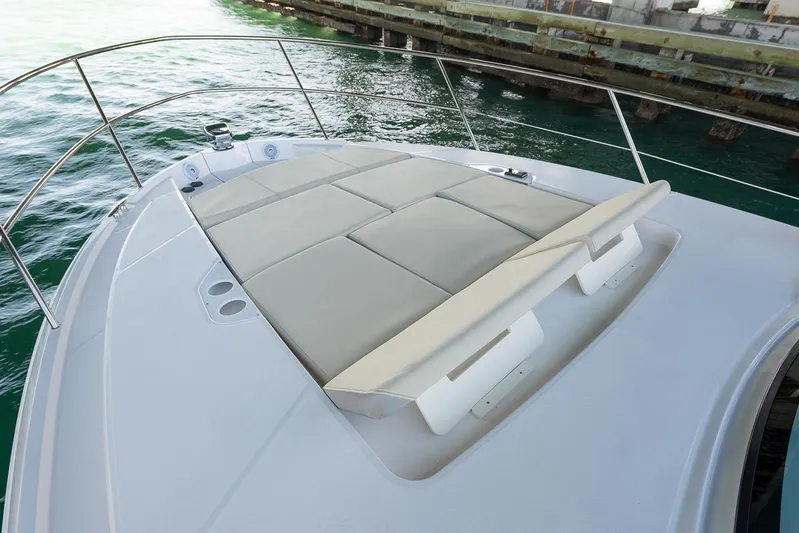  Yacht Photos Pics Manufacturer Provided Image: 2025 Regal 38 FXO boat with spacious sunbathing deck by the water.