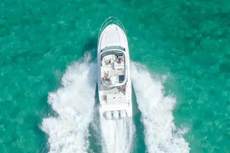  Yacht Photos Pics Manufacturer Provided Image: Aerial view of 2025 Regal 38 FXO boat cruising on turquoise water.