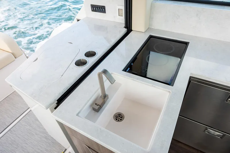  Yacht Photos Pics Manufacturer Provided Image: Modern kitchen area on 2025 Regal 38 FXO yacht with sink and stove.