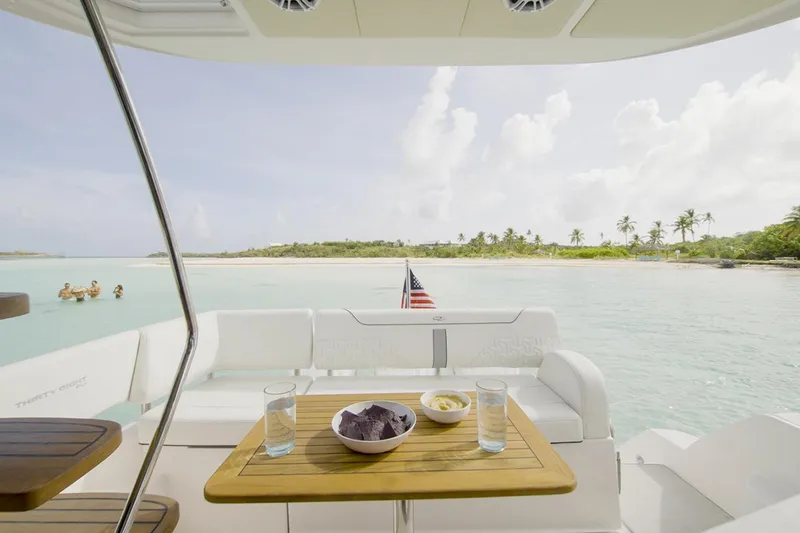  Yacht Photos Pics Manufacturer Provided Image: 2025 Regal 38 FXO yacht with snacks on deck, overlooking serene tropical waters.