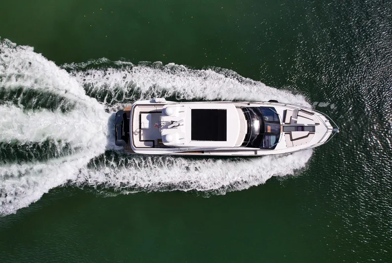 Gold Star Yacht Photos Pics Aerial view of 2020 Galeon 640 Fly yacht cruising on water.