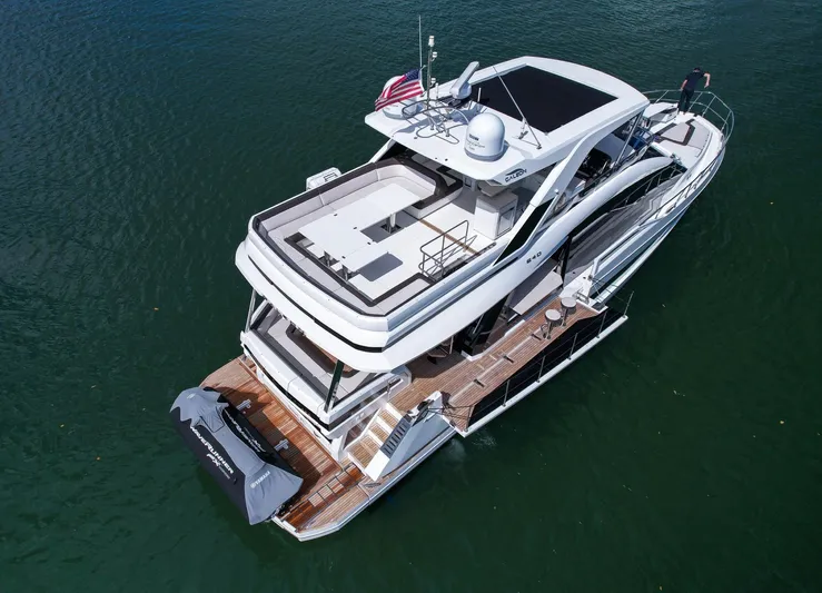 Gold Star Yacht Photos Pics 2020 Galeon 640 Fly yacht on water, aerial view, showcasing sleek design and spacious deck.