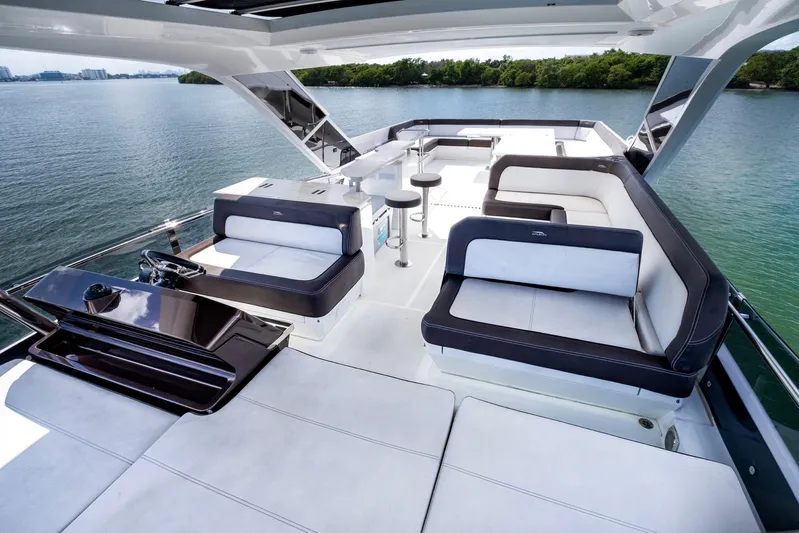 Gold Star Yacht Photos Pics Luxurious 2020 Galeon 640 Fly yacht with spacious deck and seating area on serene water.