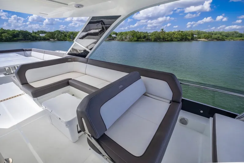 Gold Star Yacht Photos Pics Luxurious seating area on 2020 Galeon 640 Fly yacht overlooking serene waters.