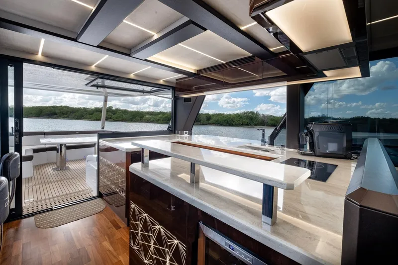Gold Star Yacht Photos Pics Luxurious interior of 2020 Galeon 640 Fly yacht with modern kitchen and scenic water view.