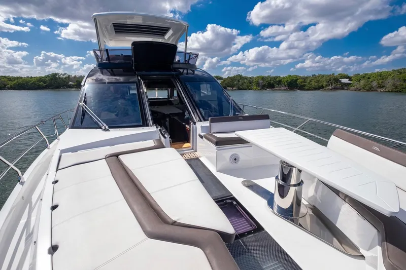 Gold Star Yacht Photos Pics Luxurious 2020 Galeon 640 Fly yacht with spacious deck and seating, under a clear blue sky.