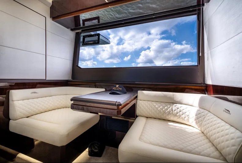 Gold Star Yacht Photos Pics Luxurious interior of 2020 Galeon 640 Fly yacht with plush seating and large window view.