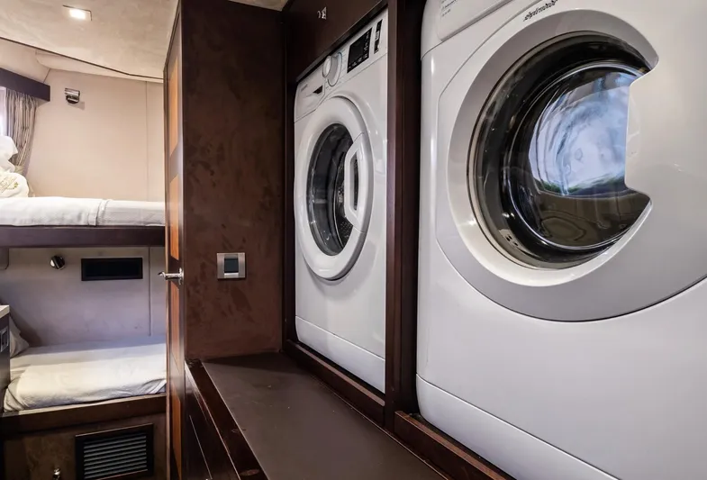 Gold Star Yacht Photos Pics Laundry area with washer and dryer in 2020 Galeon 640 Fly yacht interior.
