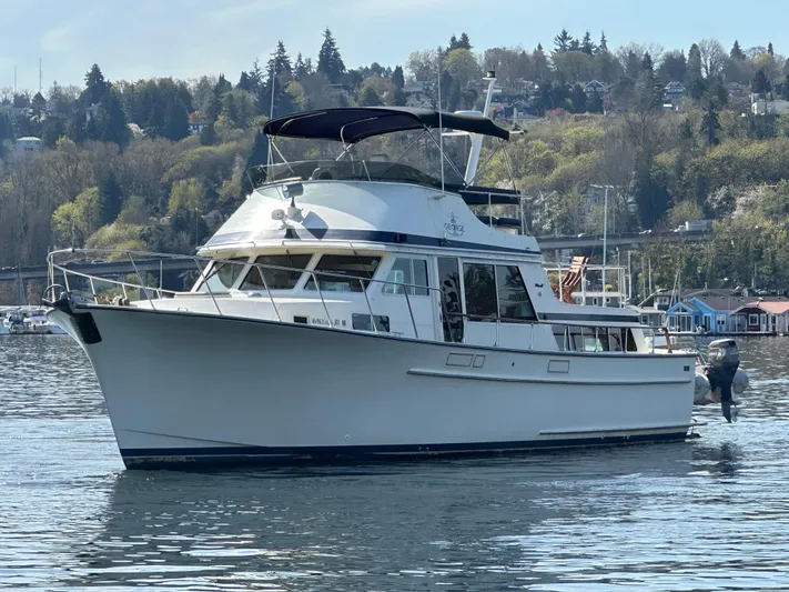  Yacht Photos Pics 1982 Tollycraft Tri Cabin yacht on calm water with scenic forested background.