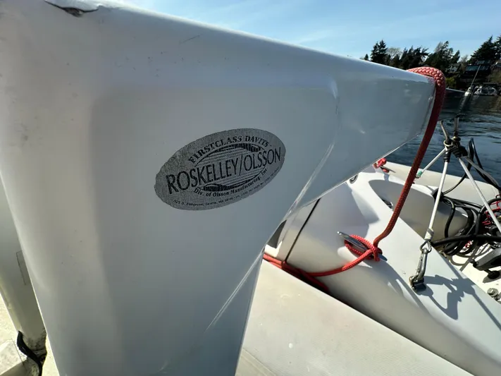  Yacht Photos Pics 1982 Tollycraft Tri Cabin boat detail with Roskelley/Olsson label, docked under clear sky.