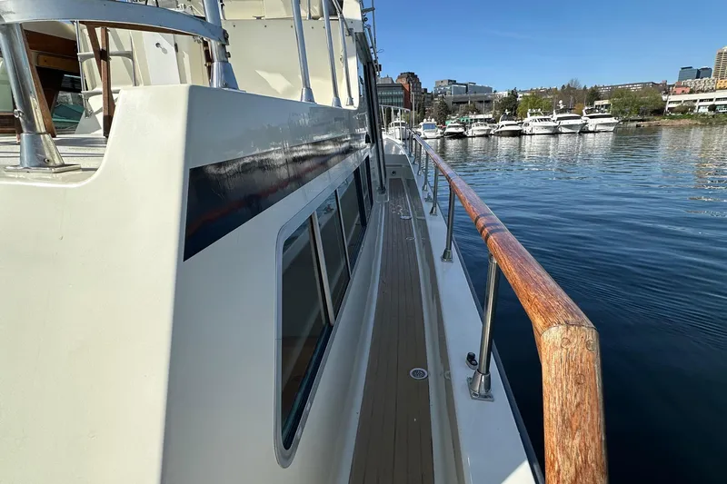  Yacht Photos Pics 1982 Tollycraft Tri Cabin yacht docked, showcasing side deck and marina view.