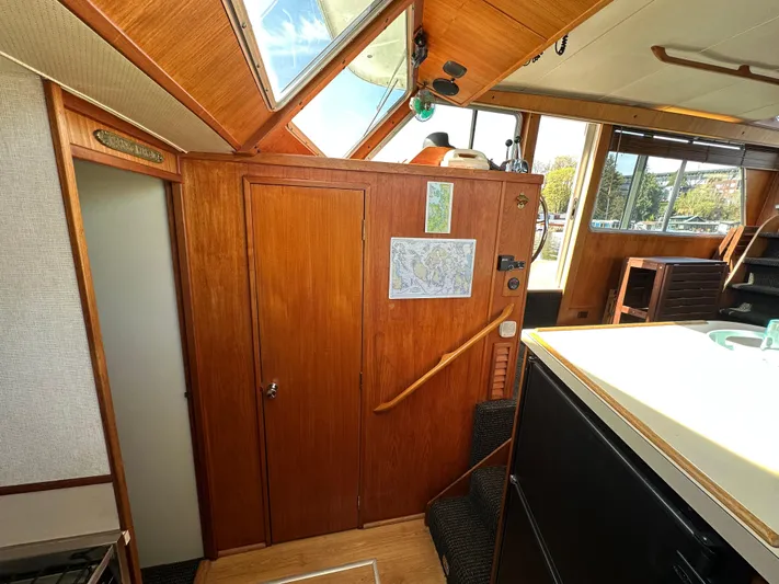  Yacht Photos Pics 1982 Tollycraft Tri Cabin interior with wood paneling and natural light.