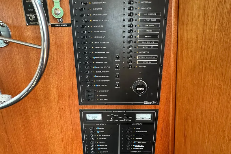  Yacht Photos Pics 1982 Tollycraft Tri Cabin control panel with switches and gauges on wooden background.