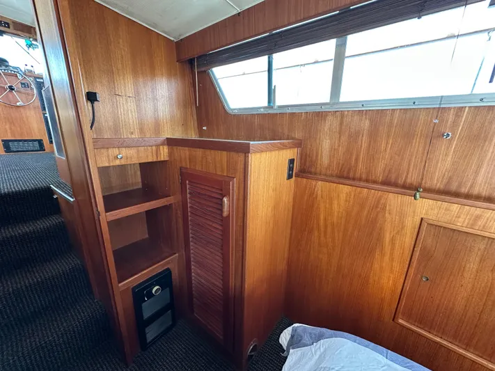  Yacht Photos Pics 1982 Tollycraft Tri Cabin interior with wooden cabinetry and carpeted flooring.