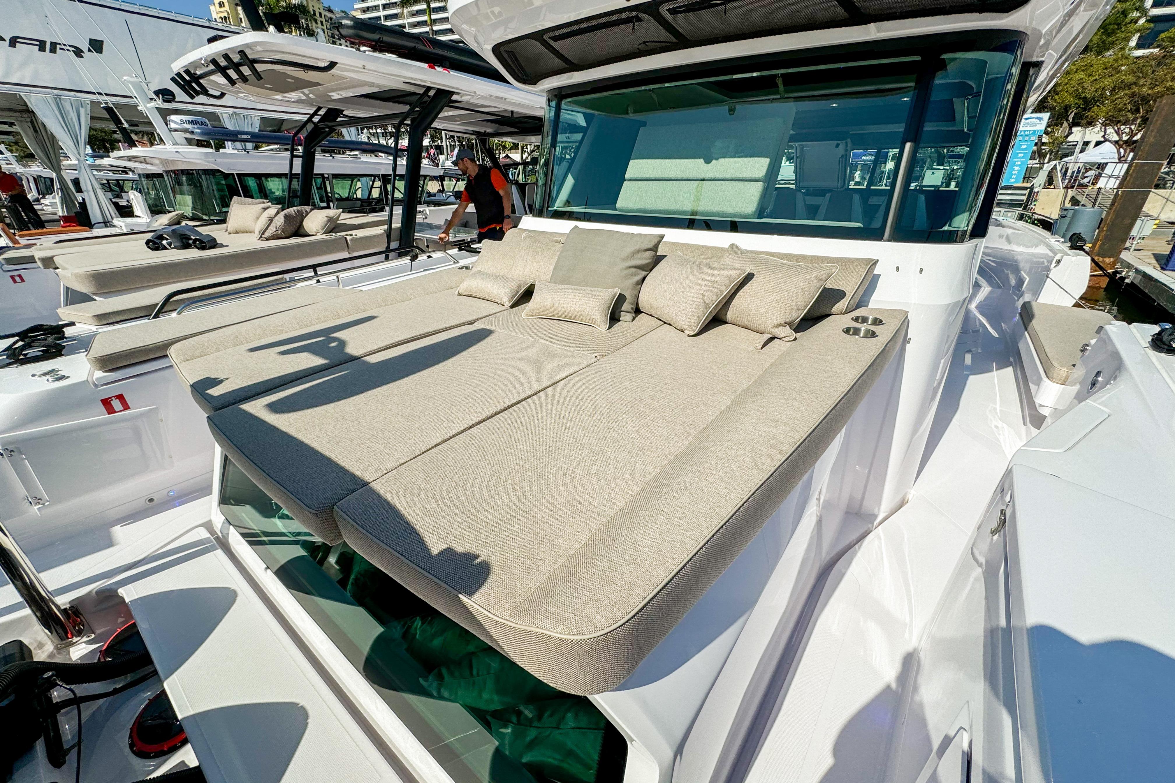 2024 Axopar 45 XC Cross Cabin with sunbathing deck and cushions, docked at marina.