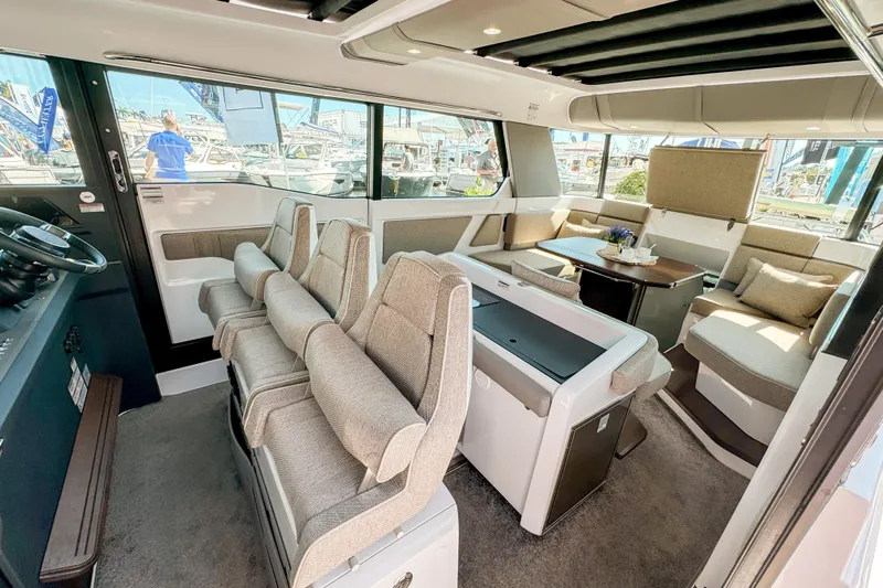  Yacht Photos Pics 2024 Axopar 45 XC Cross Cabin interior with modern seating and dining area.