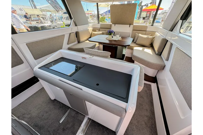  Yacht Photos Pics Interior of 2024 Axopar 45 XC Cross Cabin with modern seating and dining area.