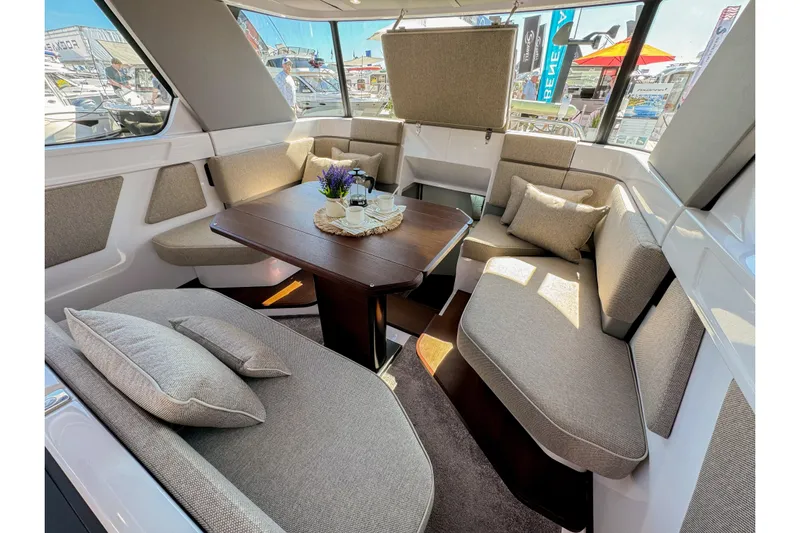 Yacht Photos Pics Luxurious interior of 2024 Axopar 45 XC Cross Cabin with plush seating and elegant table.