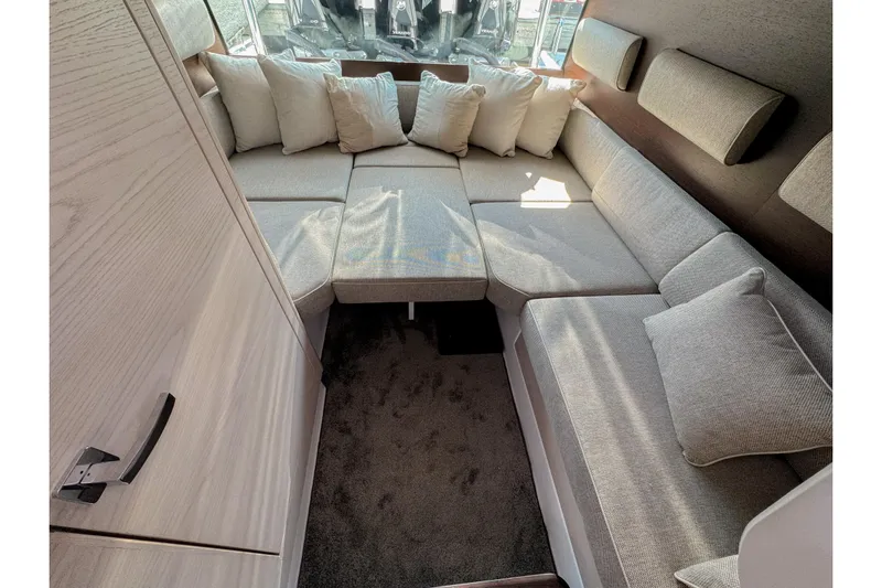  Yacht Photos Pics 2024 Axopar 45 XC Cross Cabin interior with cozy seating and cushions.
