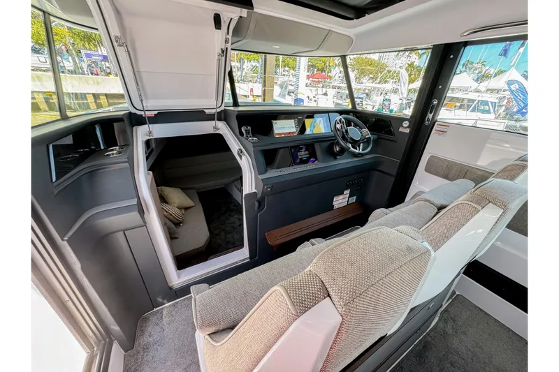  Yacht Photos Pics 2024 Axopar 45 XC Cross Cabin interior with modern helm and seating.