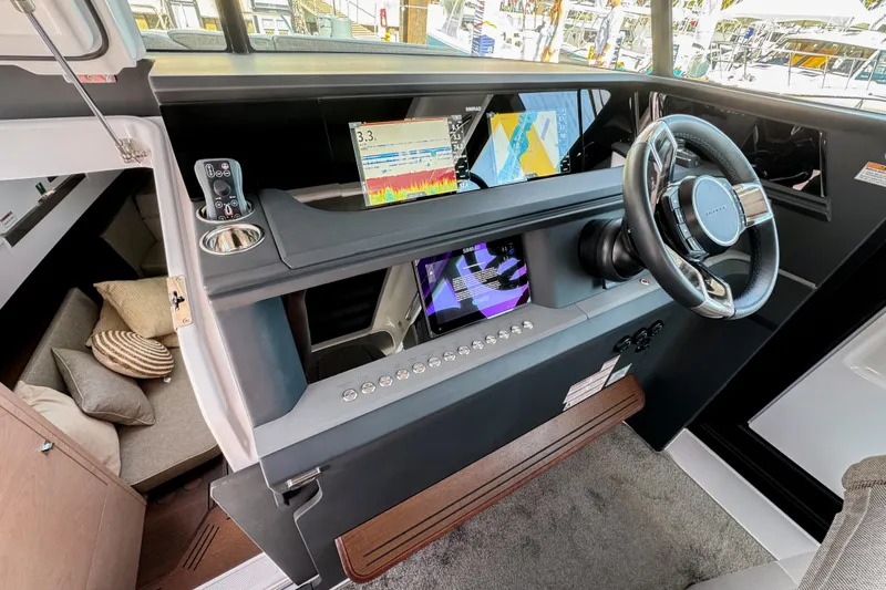  Yacht Photos Pics 2024 Axopar 45 XC Cross Cabin helm with modern navigation displays and cozy cabin area.