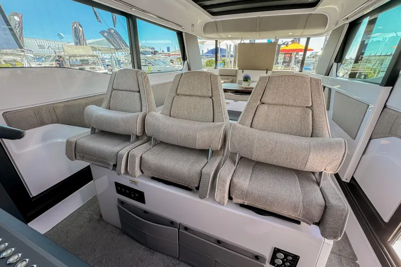  Yacht Photos Pics 2024 Axopar 45 XC Cross Cabin interior with three plush seats and modern design.