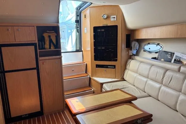  Yacht Photos Pics Interior of 2000 Tiara Yachts 4100 Open with beige seating and wooden cabinetry.