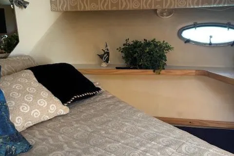  Yacht Photos Pics Cozy cabin interior of 2000 Tiara Yachts 4100 Open with elegant bedding and decor.