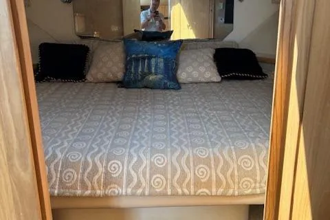  Yacht Photos Pics 2000 Tiara Yachts 4100 Open cabin interior with bed and decorative pillows.