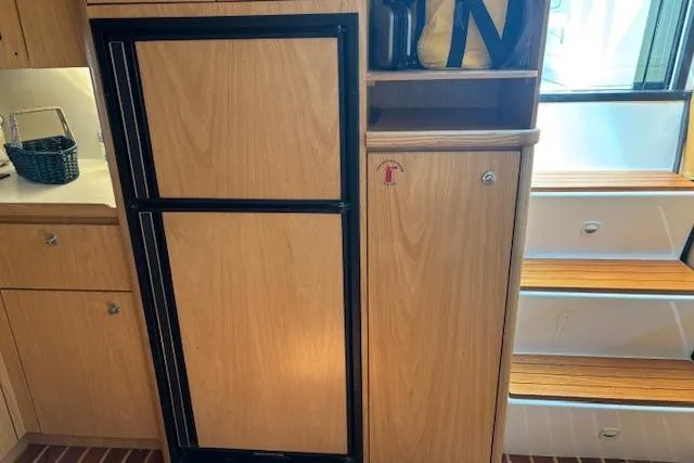  Yacht Photos Pics 2000 Tiara Yachts 4100 Open interior with wooden cabinetry and steps.