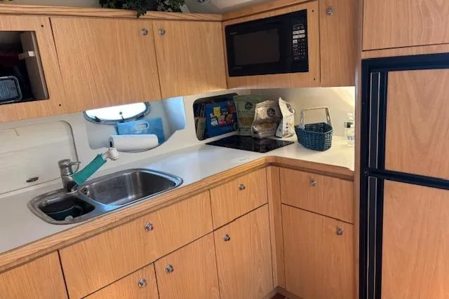  Yacht Photos Pics 2000 Tiara Yachts 4100 Open kitchen with wooden cabinets and modern appliances.