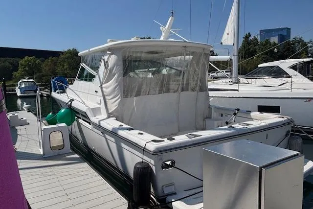  Yacht Photos Pics 2000 Tiara Yachts 4100 Open docked, featuring a spacious deck and clear canopy.