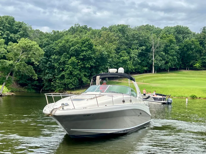  Yacht Photos Pics 2006 Sea Ray 340 Sundancer cruising on a scenic lake with lush green trees.