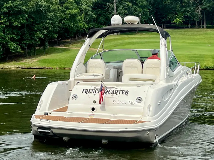  Yacht Photos Pics 2006 Sea Ray 340 Sundancer boat on water, rear view, with lush green background.