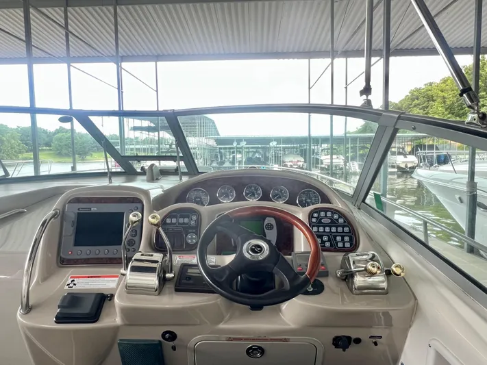 Yacht Photos Pics 2006 Sea Ray 340 Sundancer helm with modern controls and gauges, docked in a marina.