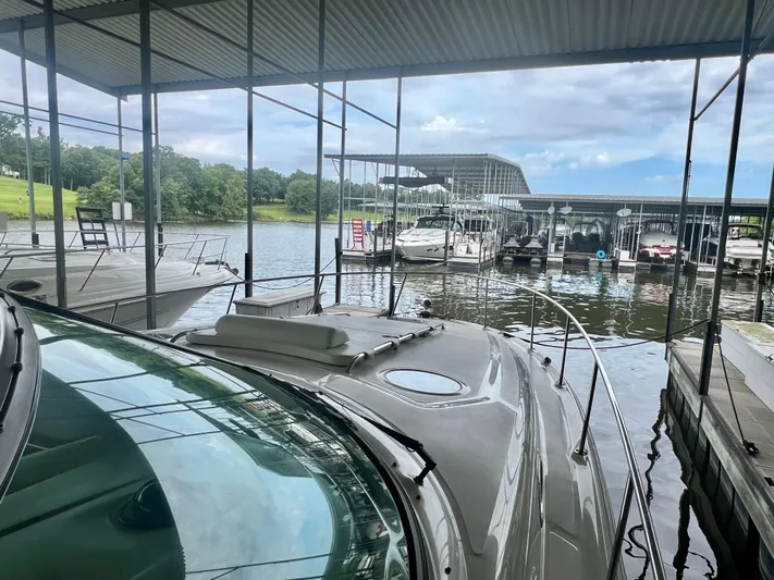  Yacht Photos Pics 2006 Sea Ray 340 Sundancer docked at a marina under a covered structure.